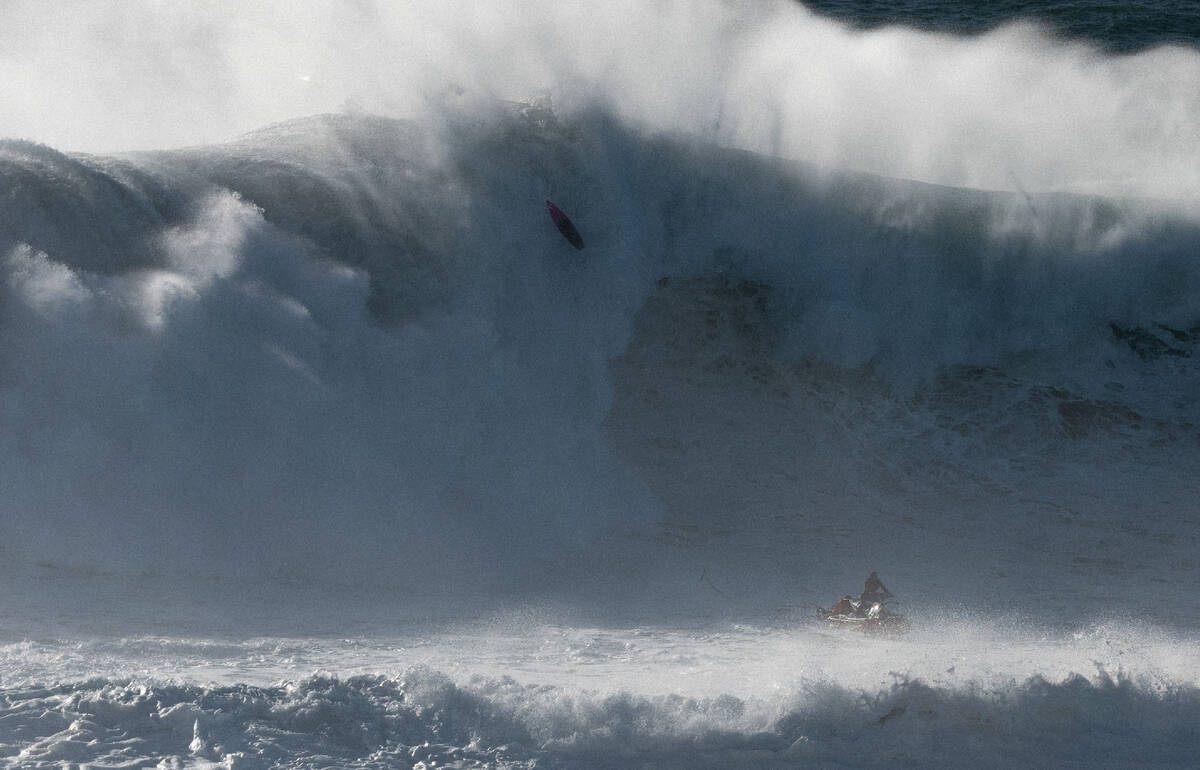 Rescue jetski under a massive Nazaré wave